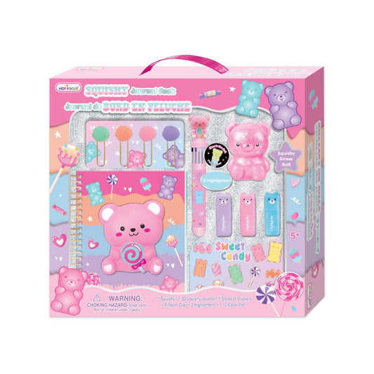 A children's craft kit in retail packaging, featuring a pink bear-themed box with a handle. The kit includes a glittery notebook, colorful sponges, paintbrushes, stickers, and candy-shaped accessories visible through a clear window on the front of the box.