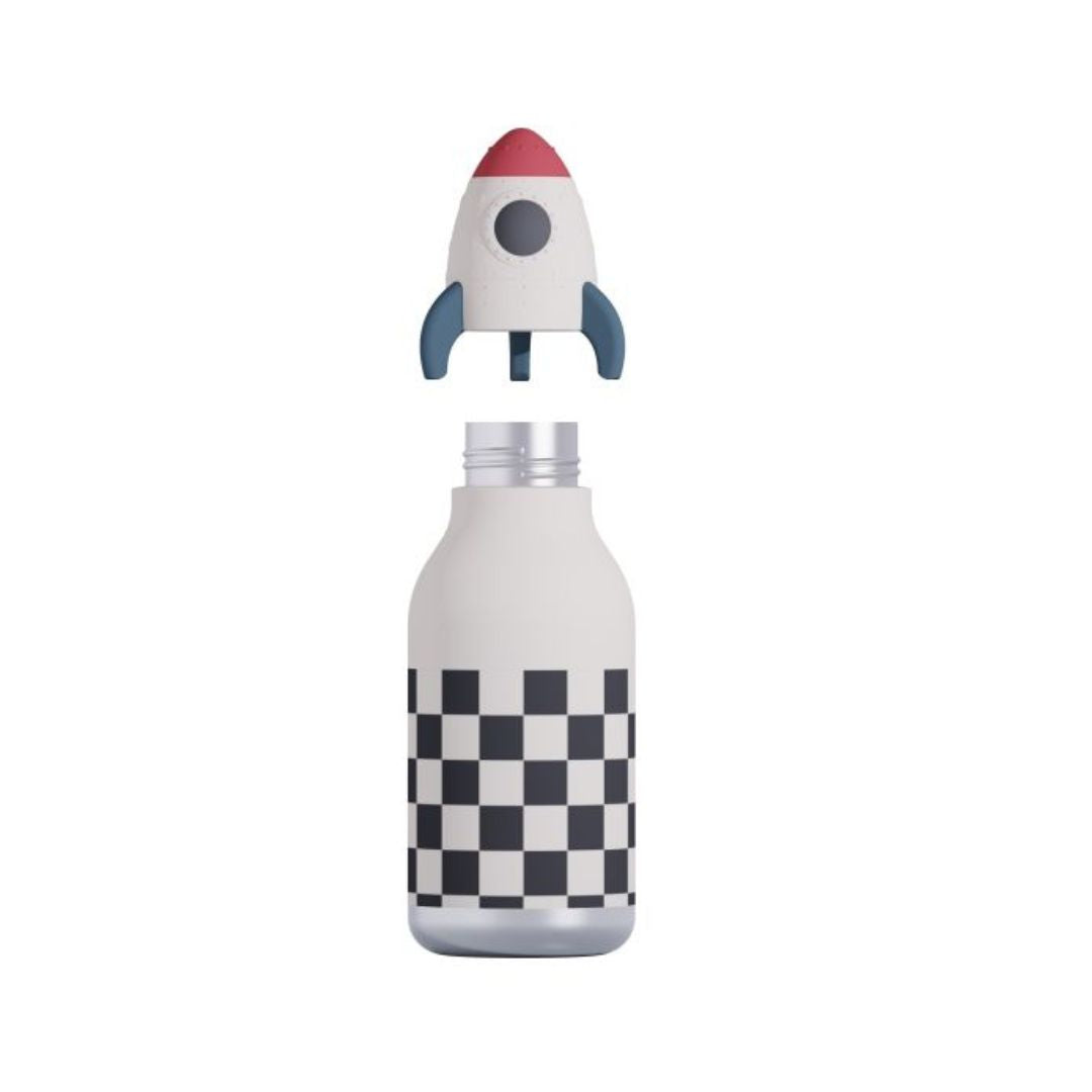 A white insulated bottle with a black and white checkerboard pattern near the bottom, topped with a detachable rocket-shaped lid featuring a red nose cone, gray fins, and a gray circular window.