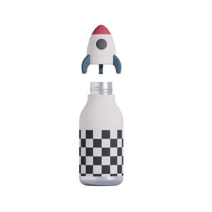 A white insulated bottle with a black and white checkerboard pattern near the bottom, topped with a detachable rocket-shaped lid featuring a red nose cone, gray fins, and a gray circular window.