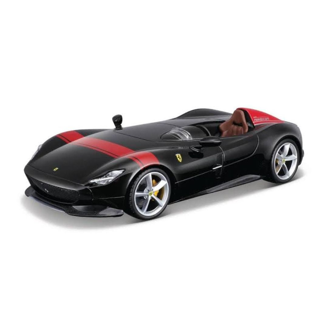 A black diecast model of a Ferrari sports car with red stripes and a brown interior, shown on a clean white background.