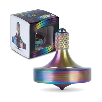 An iridescent metallic spinning top shown in front of its retail box on a clean white background. The top has a rainbow finish with purple, blue, green, and gold tones, and the box features a clear window displaying the product inside.