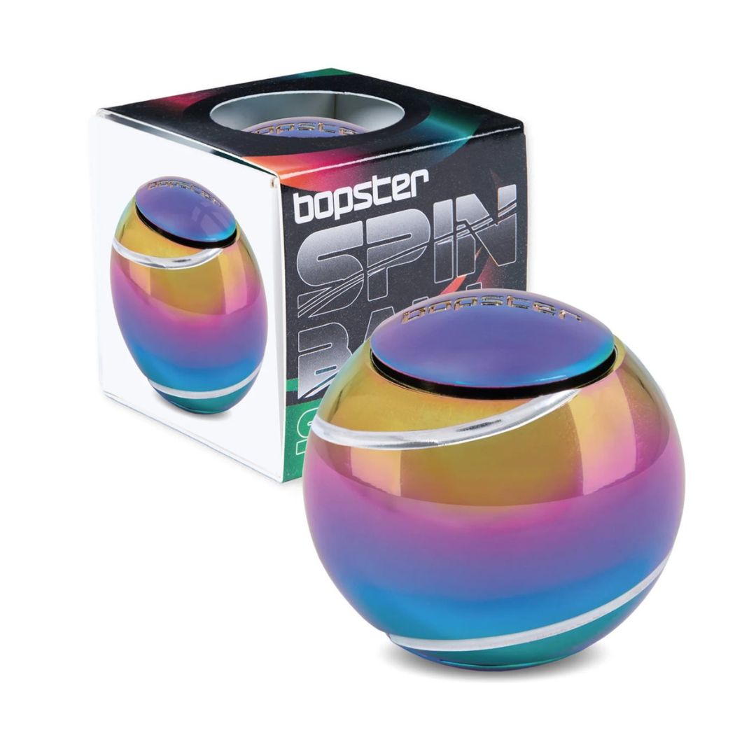 A Bopster Spin Ball portable speaker in an iridescent rainbow finish, shown in front of its retail packaging box on a white background.