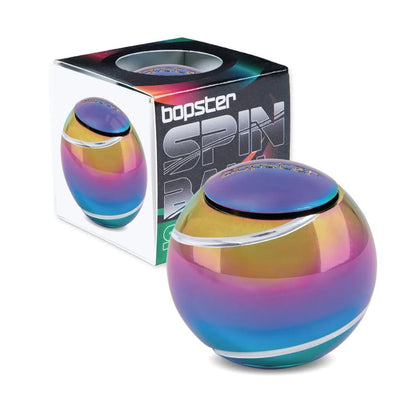 A Bopster Spin Ball portable speaker in an iridescent rainbow finish, shown in front of its retail packaging box on a white background.