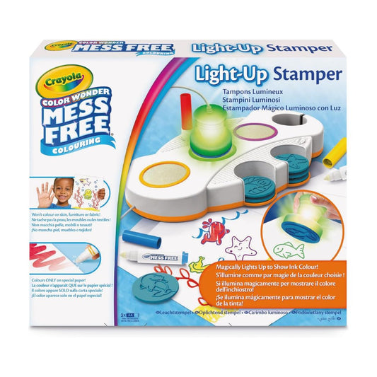 Crayola Color Wonder Mess Free Light-Up Stamper toy set in its original retail packaging, featuring a white and orange plastic stamping tray with glowing colored light-up windows and included markers.