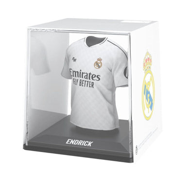 Real Madrid jersey in a clear display case with visible branding.