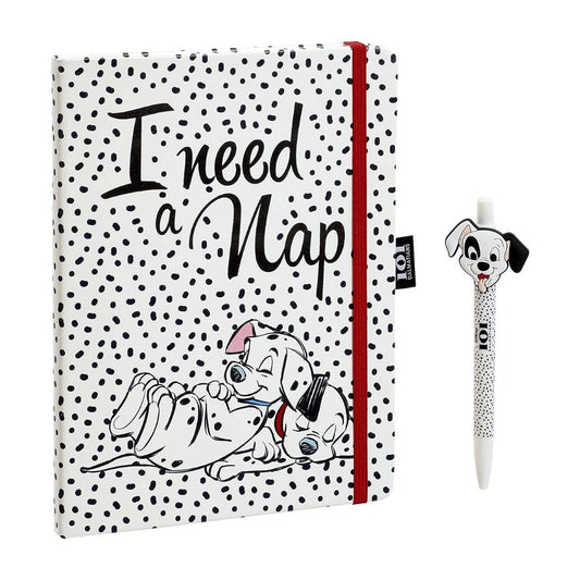 A notebook with a white cover covered in black polka dots, featuring the text 'I need a Nap' and a cartoon Dalmatian illustration, shown alongside a matching pen with a Dalmatian character on a white background.