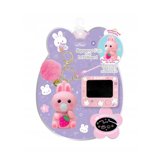A pink rabbit-themed squeeze toy keychain set on a purple retail backing card. The set includes a pink bunny figure holding a strawberry, a fluffy pink pom-pom, a small digital screen board, and a flower-shaped control pad, all attached to a keychain ring.