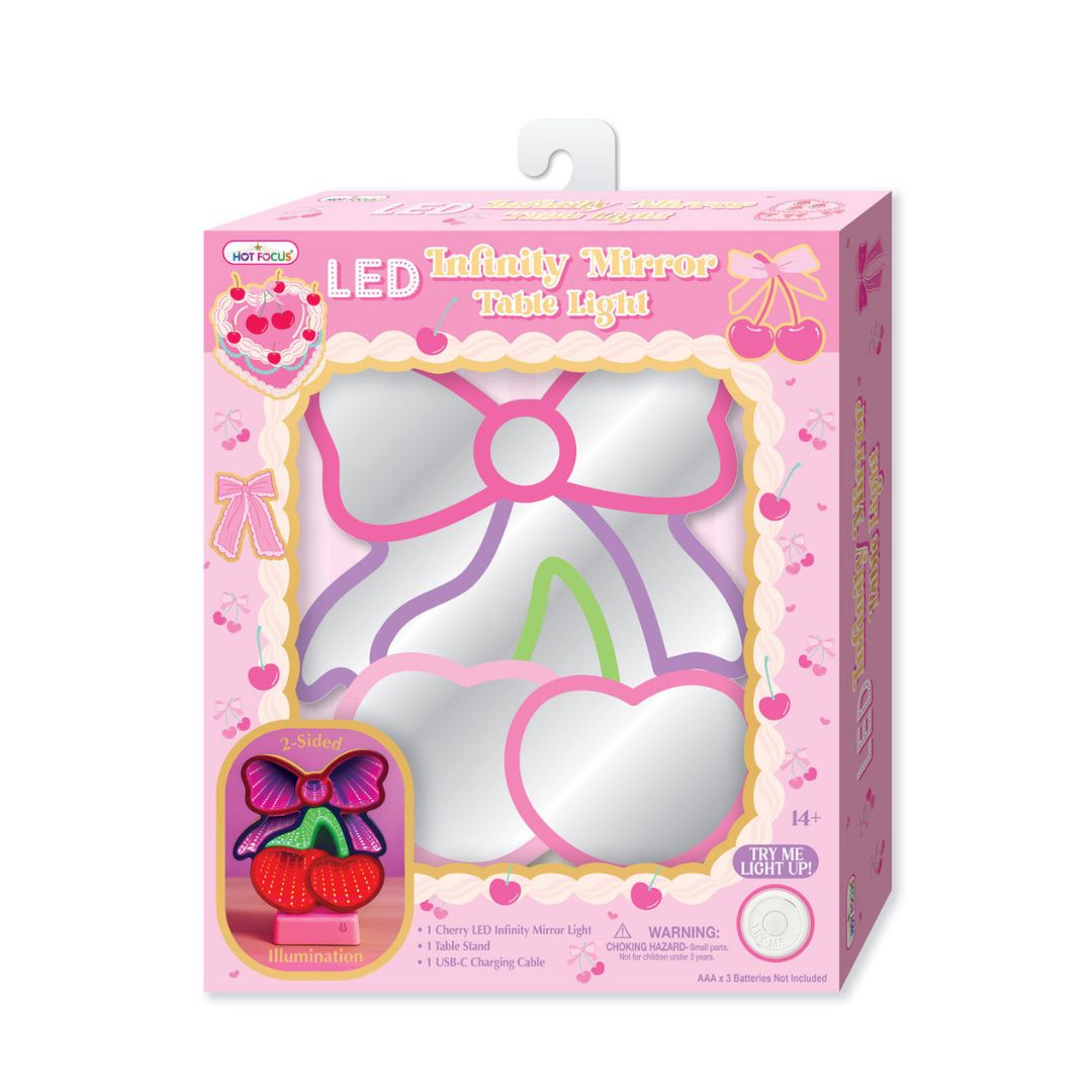 A retail-packaged Miraculous LED Infinity Mirror Table Light toy by Mattel. The product is shown inside its pink cherry-themed cardboard box, which features a clear window displaying the pink and purple LED mirror frame, along with an illustration of the butterfly-shaped light on the lower left.