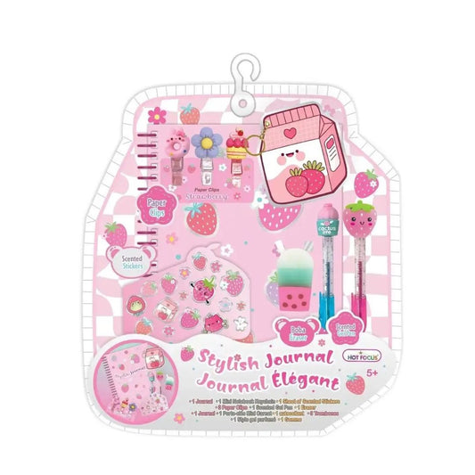 A pink and white strawberry-themed stationery gift set in a hanging plastic package, featuring a journal, pens, stickers, and small accessories with cute cartoon illustrations.