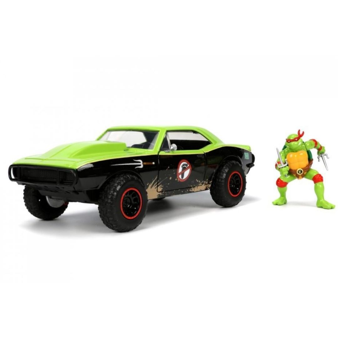 A green and black muscle car toy with red-rimmed wheels, shown next to a green Teenage Mutant Ninja Turtle action figure on a clean white background.