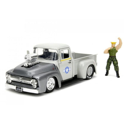 A die-cast model pickup truck in a two-tone gray and white livery with a chrome engine block and a blue star insignia on the side door, shown next to a small military-style toy soldier figure on a white background.
