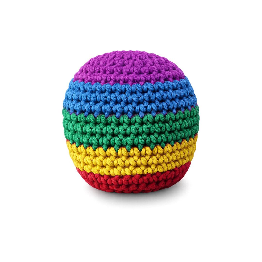 A round, hand-crocheted pouf or ottoman featuring horizontal rainbow stripes of purple, blue, green, yellow, and red on a white background.