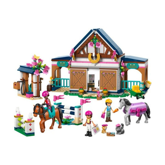 A toy building block set featuring a horse stable with a decorated roof, a small stable accessory area, a jumping fence, and several small minifigures with horses, shown on a plain white background.