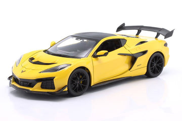 A yellow and black die-cast model of a Corvette C8 sports car, shown from a three-quarters front angle on a clean white background.