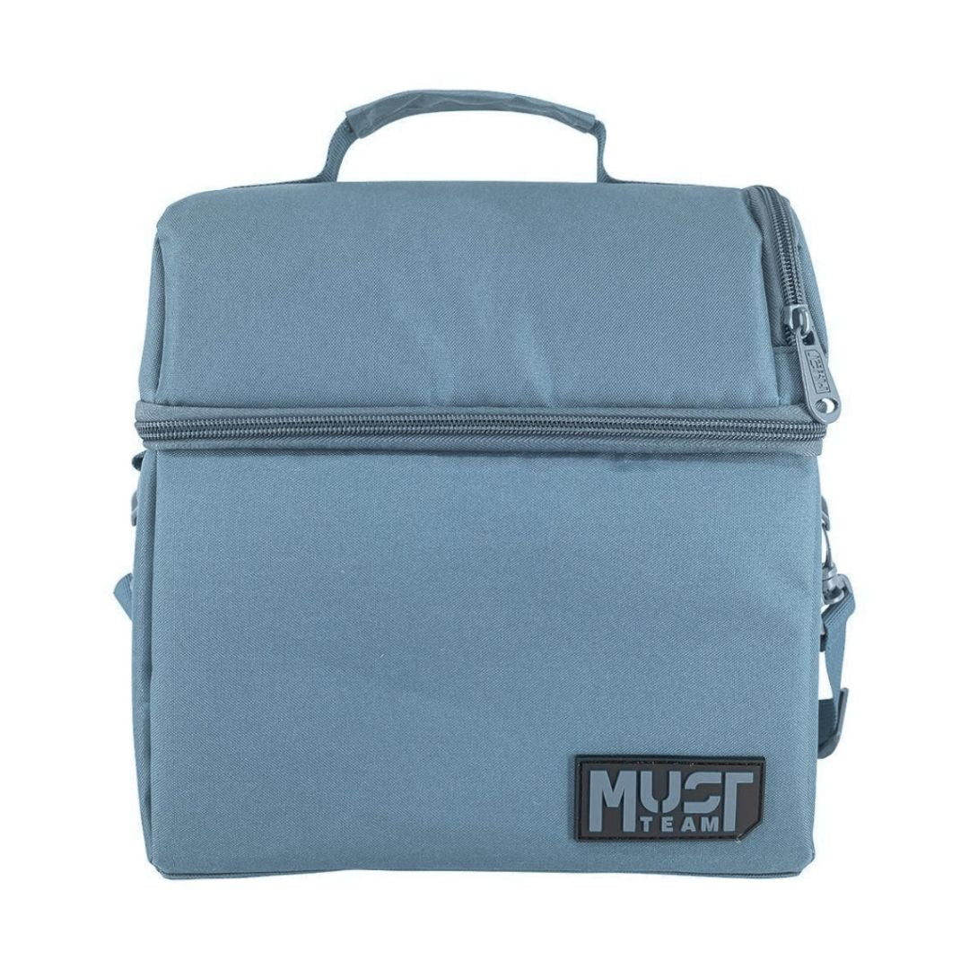 A dusty blue insulated lunch bag with a top handle, a horizontal zipper, and a black 'MUST TEAM' logo patch on the bottom right, shown against a plain white background.