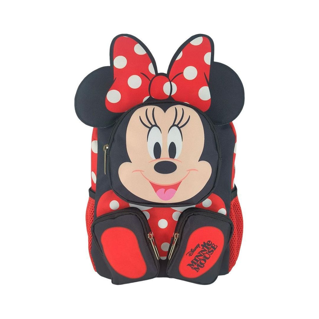 A Minnie Mouse backpack featuring a large 3D face design with a red and white polka dot bow, black mouse ears, and red polka dot pattern, shown on a plain white background.