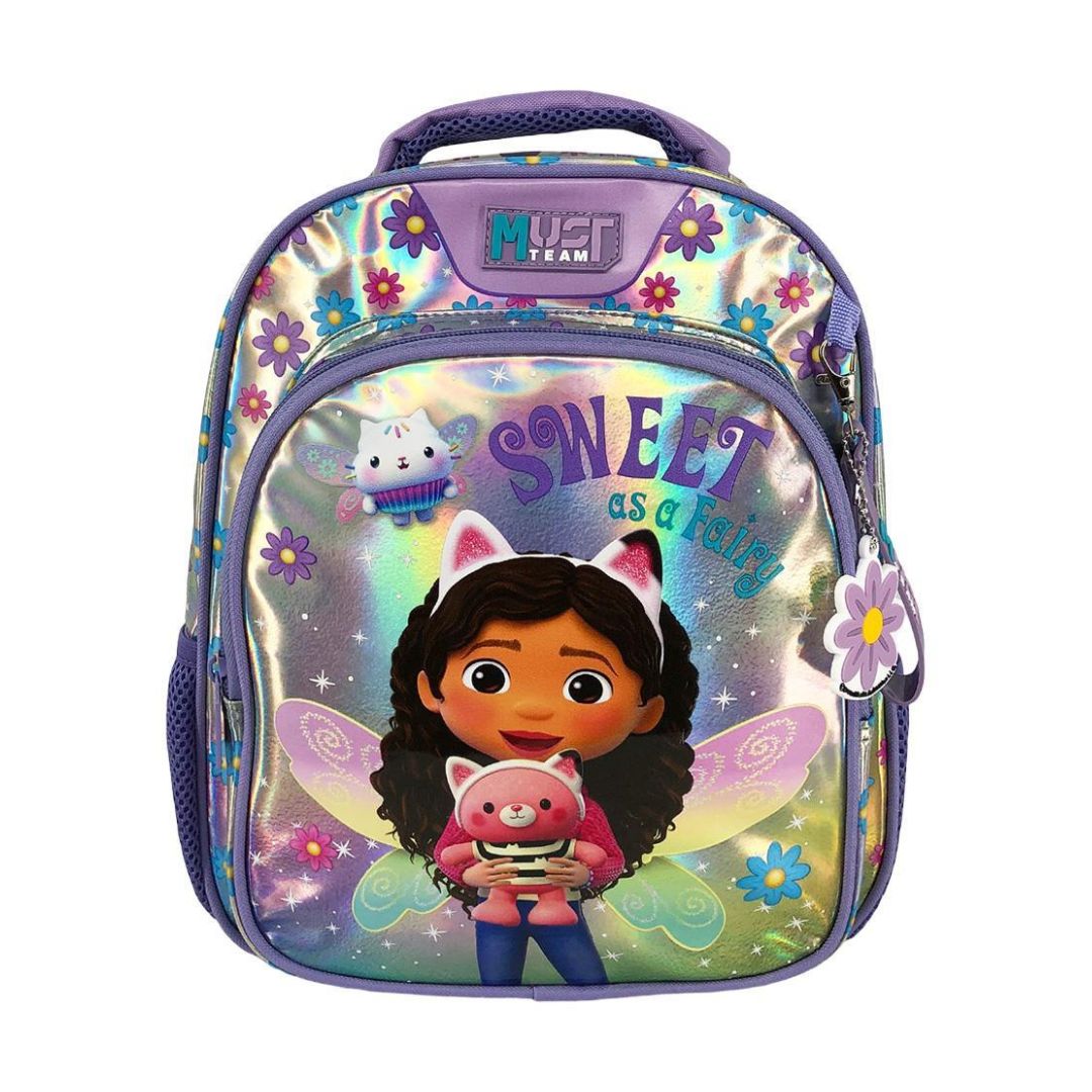 A kids' school backpack featuring a holographic silver finish with colorful floral patterns and a printed illustration of Dora holding a pink pig, with the text 'SWEET as a baby' and a 'MUST TEAM' logo on the front.