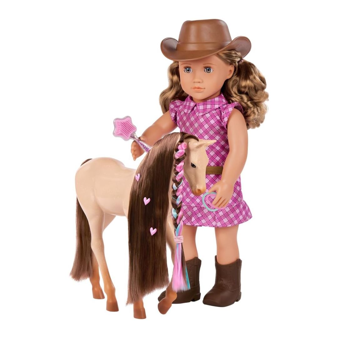An 18-inch doll with brown hair wearing a brown cowboy hat and a pink gingham dress, standing next to a beige toy horse with a dark brown mane and pink heart accents. The doll holds a pink star wand and a blue ring, set against a plain white background.