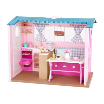 A pink and blue toy house dollhouse with a kitchen, dining table, and small accessories, isolated on a white background.