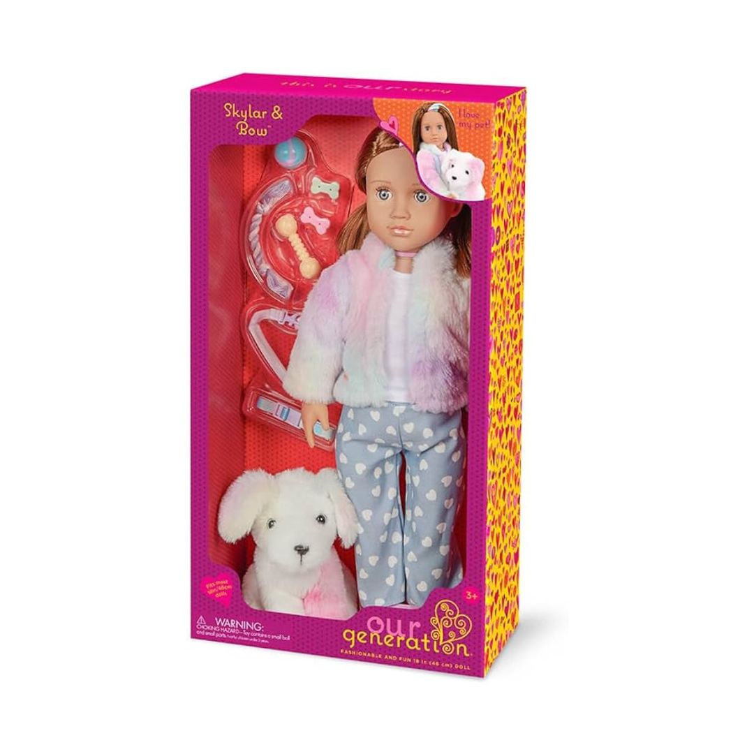 Our Generation Stylar & Gwendy doll set in its original pink packaging, featuring a doll with brown hair, a pastel rainbow jacket, and blue heart-patterned pants, along with a white plush dog toy and a pink pet playset.
