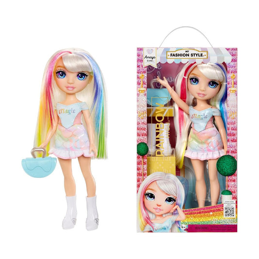 A fashion doll named Magic with pastel rainbow hair, shown both outside its packaging on the left and inside its retail box on the right. The doll wears a light blue top and a pink-and-white ruffled skirt, and comes with a turquoise purse.