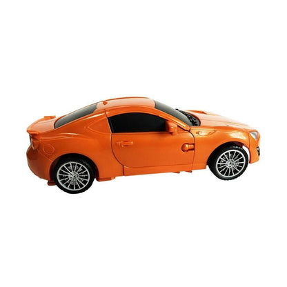 An orange toy sports car with black windows and silver multi-spoke wheels, shown in a side profile on a solid white background.