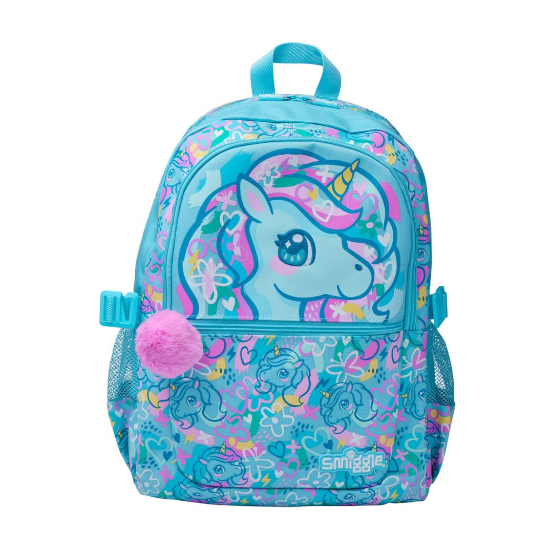 A Smiggle brand school backpack in vibrant turquoise blue, decorated with a large cartoon unicorn graphic on the front pocket, a pink fluffy pom-pom charm, and a colorful floral and unicorn pattern across the lower section.