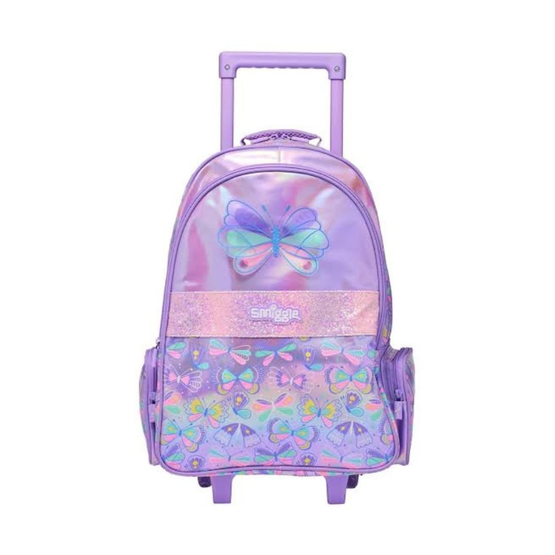 A purple rolling backpack with a butterfly design, featuring a transparent iridescent upper section, a glittery pink band with the brand name 'Smilez' in the center, and a patterned lower section with multiple butterflies. It has a telescoping handle and two wheels.