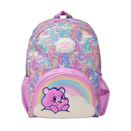 A pastel pink and purple Care Bears backpack featuring a colorful cartoon bear pattern, a pink front pocket with a rainbow and cloud applique, and a white cloud patch on the front.