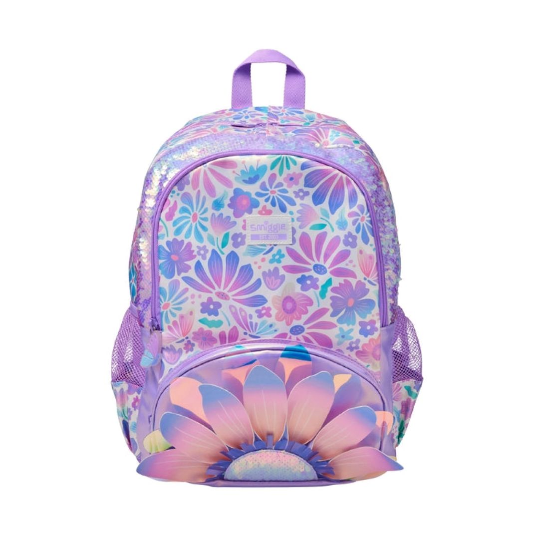 A pastel purple backpack with a floral pattern and a large flower graphic on the front pocket, shown against a plain white background.