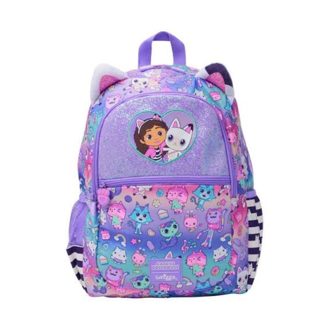 A purple and pink cartoon backpack featuring Dora and Boots graphics, cat ears on the top, and a playful multicolor pattern on a white background.