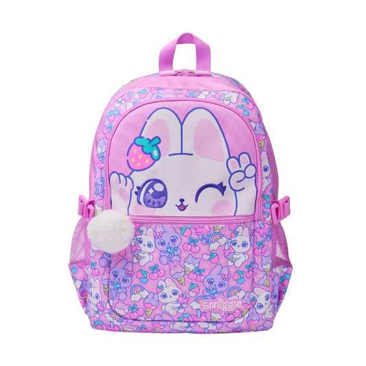 A pink children's backpack featuring a cute cartoon bunny face on the front pocket, surrounded by pastel floral patterns. The backpack has a top handle, side mesh pockets, and a white pom-pom charm.