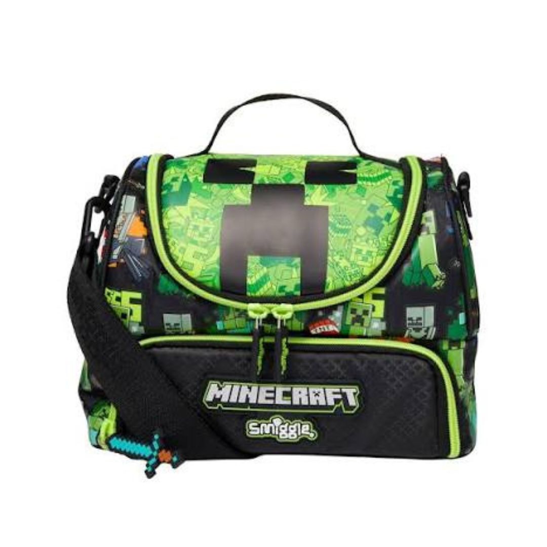 A Minecraft-themed lunch bag by Smiggle, featuring a green and black pixelated block pattern, a top handle, and a black front pocket with the Minecraft logo.