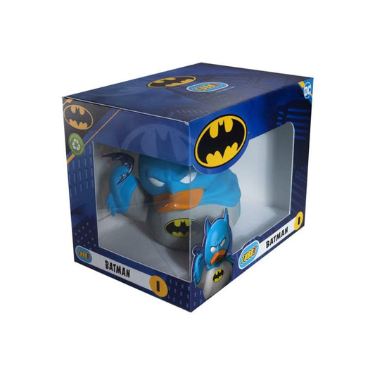 A Batman-themed novelty toilet paper holder in its original retail packaging. The product features a blue and gray body with a yellow bat logo, visible through a clear plastic window on a dark blue box decorated with Batman logos.
