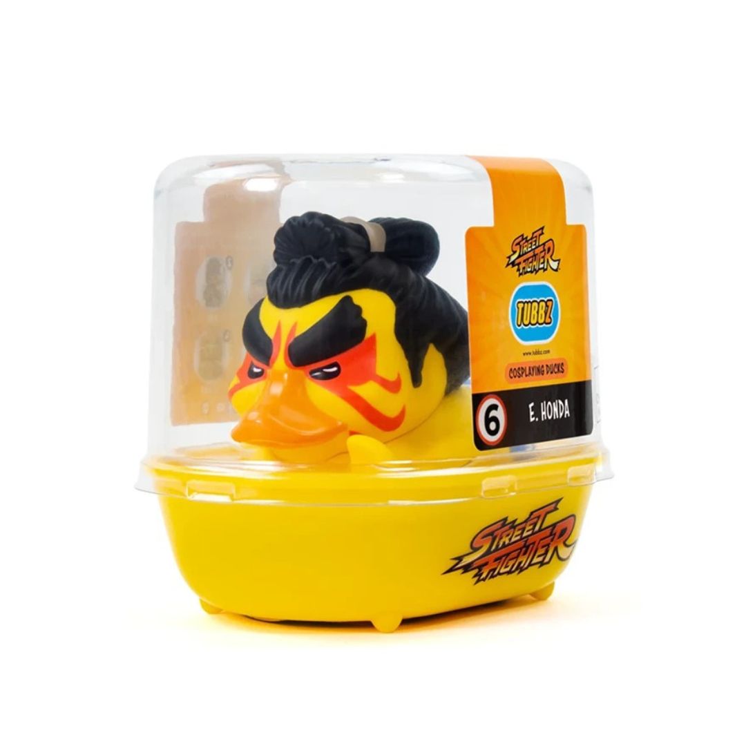 A Street Fighter 6 E. Pomba duck toy in its original clear plastic blister packaging with a yellow base and orange label.